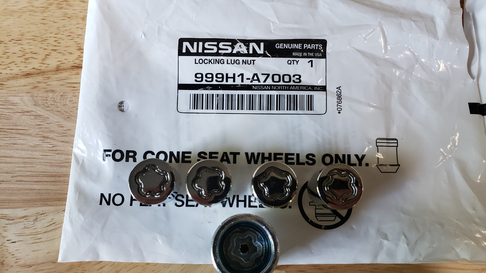 NEW GENUINE NISSAN WHEEL LOCK SET OF 4 IN SEALED NISSAN BAG 999H1A7003