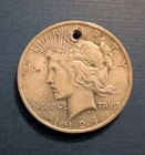 1924 peace silver dollar hole drilled in top. well circulating