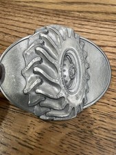 vintage Radial Co-Op Agri-Trac belt buckle tire wheel detail