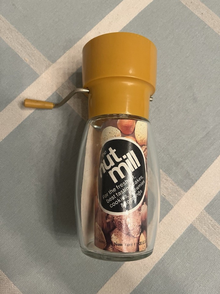 A pristine, never-used Gemco glass nut mill with its original label intact — a genuine mid-century kitchen artifact in new-old-stock condition.