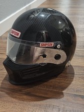 Simpson Carbon Bandit  racing helmet in a glo...