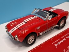 1:34 scale red Shelby Cobra 427 S/C diecast model toy car. Pull back action....