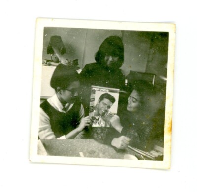 Women displaying / admiring pop pics magazine  - Vintage snapshot found  photo.