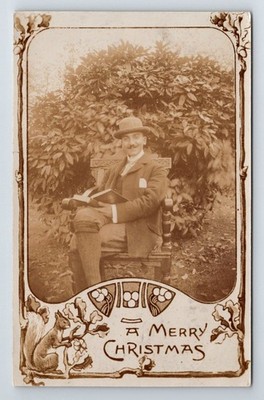 Christmas Greetings: Man Reading Book. Plus Fours. Squirrel. Unposted Postcard.