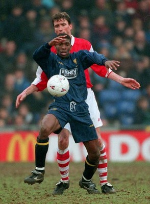 Efan Ekoku of Wimbledon and Andy Linighan of Arsenal challenge Wim- Old Photo