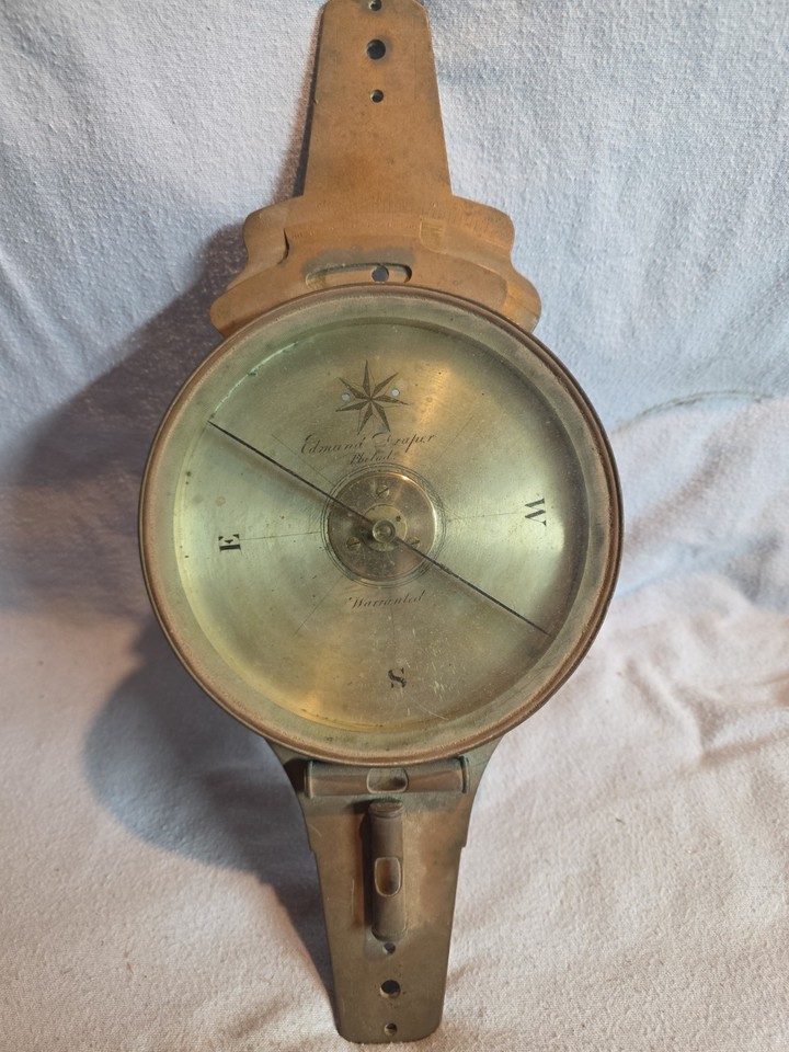 An 1860s brass surveyor's compass by Edmund Draper — the kind of artifact that makes you feel like you're planning a westward expedition.