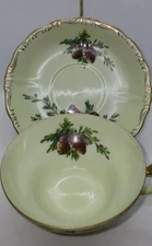 Antique Porcelain/China 3-footed cup and saucer w/pinecones & gold filigree trim