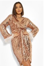 Dazzle in this rose gold sequin dress. Features chic feather cuffs. Size: 12
