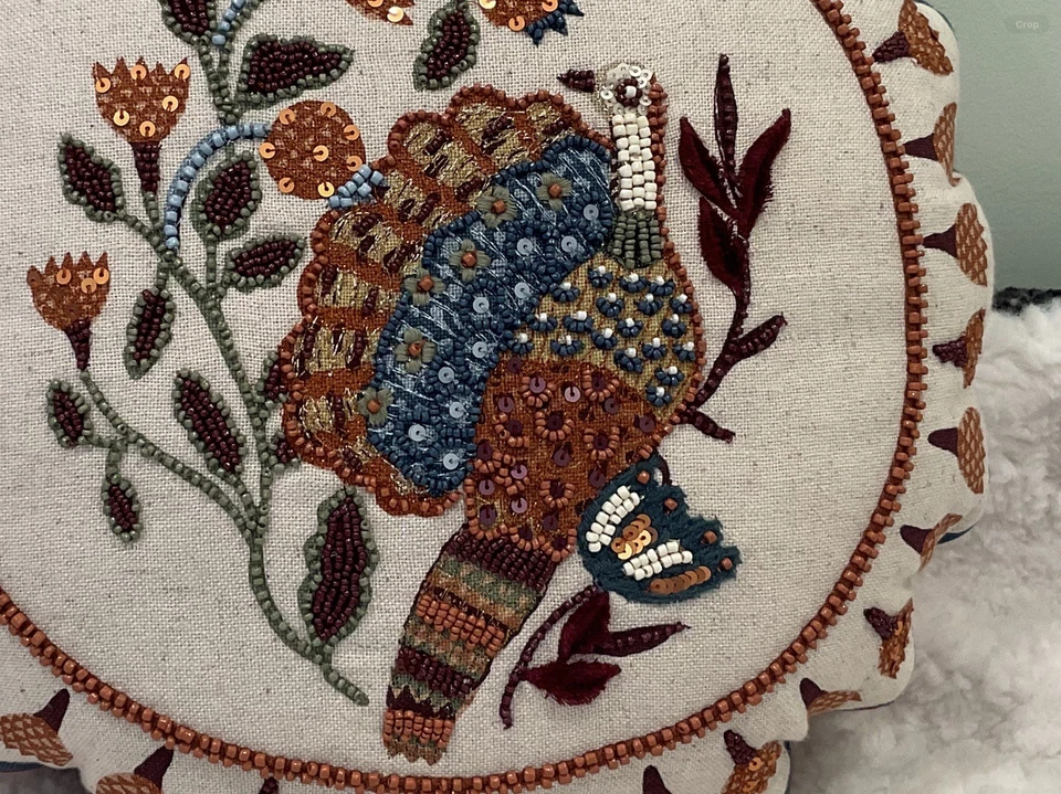 The round decorative throw pillow and beaded design of a Peacock. - Image 3 of 4