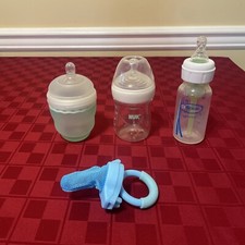 Baby Bottles Lot of 3 (Ola’, NUK, Dr. Brown’s Anti-colic) & Baby Pacifier (?)
