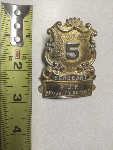 VINTAGE R. J. F. SECURITY SERVICE SERGEANT METAL HAT BADGE #5 GOLD COLOR