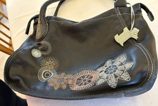 Black Radley handbag with embroidered geometric/floral design and dog tag