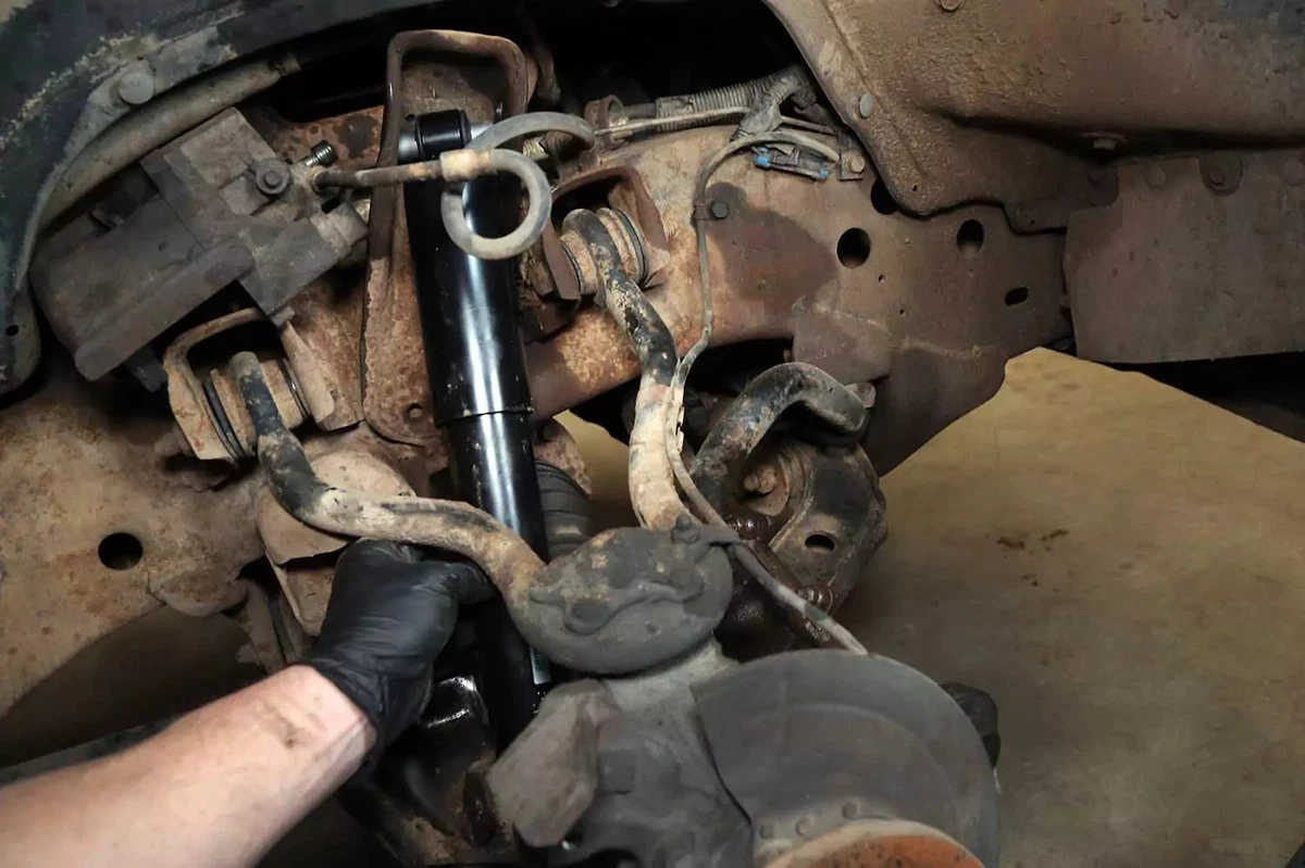 Installing the new shock absorber.