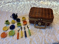 A COLLECTABLE WICKER PICNIC BASKET AND CERAMIC TEA SET, OPENED UP BUT NEVER USED
