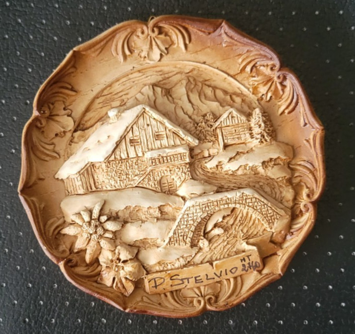 Vtg German Carved Wood Resin 3D Wall Plate Says D STELVIO 4 inch round