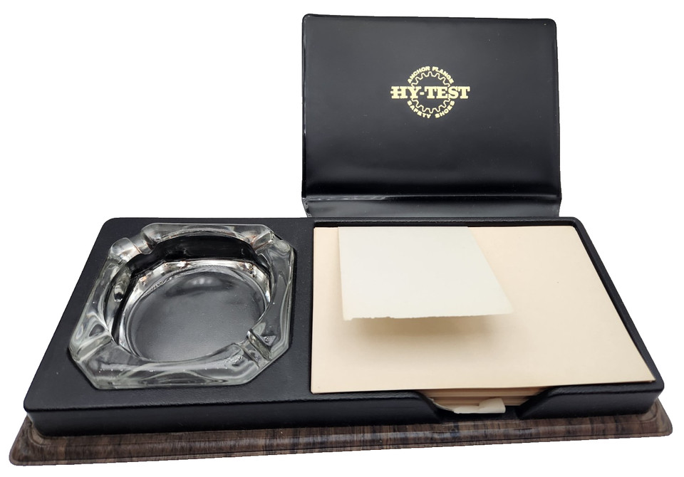 NOS (new old stock) mid-century desk set — ashtray plus note pad holder — branded by a defunct safety shoe company, still in its original box and dripping in Mad Men energy.