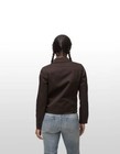 Brown canvas FILSON women’s jacket with long sleeves, button front, and two front flap chest pockets.