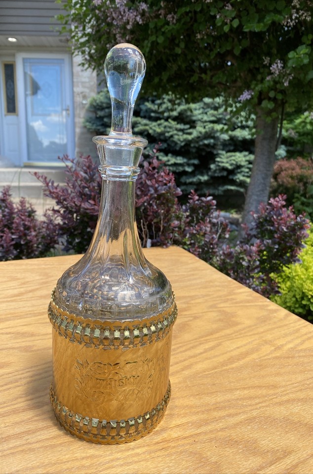 A round vintage glass whiskey decanter that comes in its own fitted case — looks like something a Bond villain would pour Scotch from.