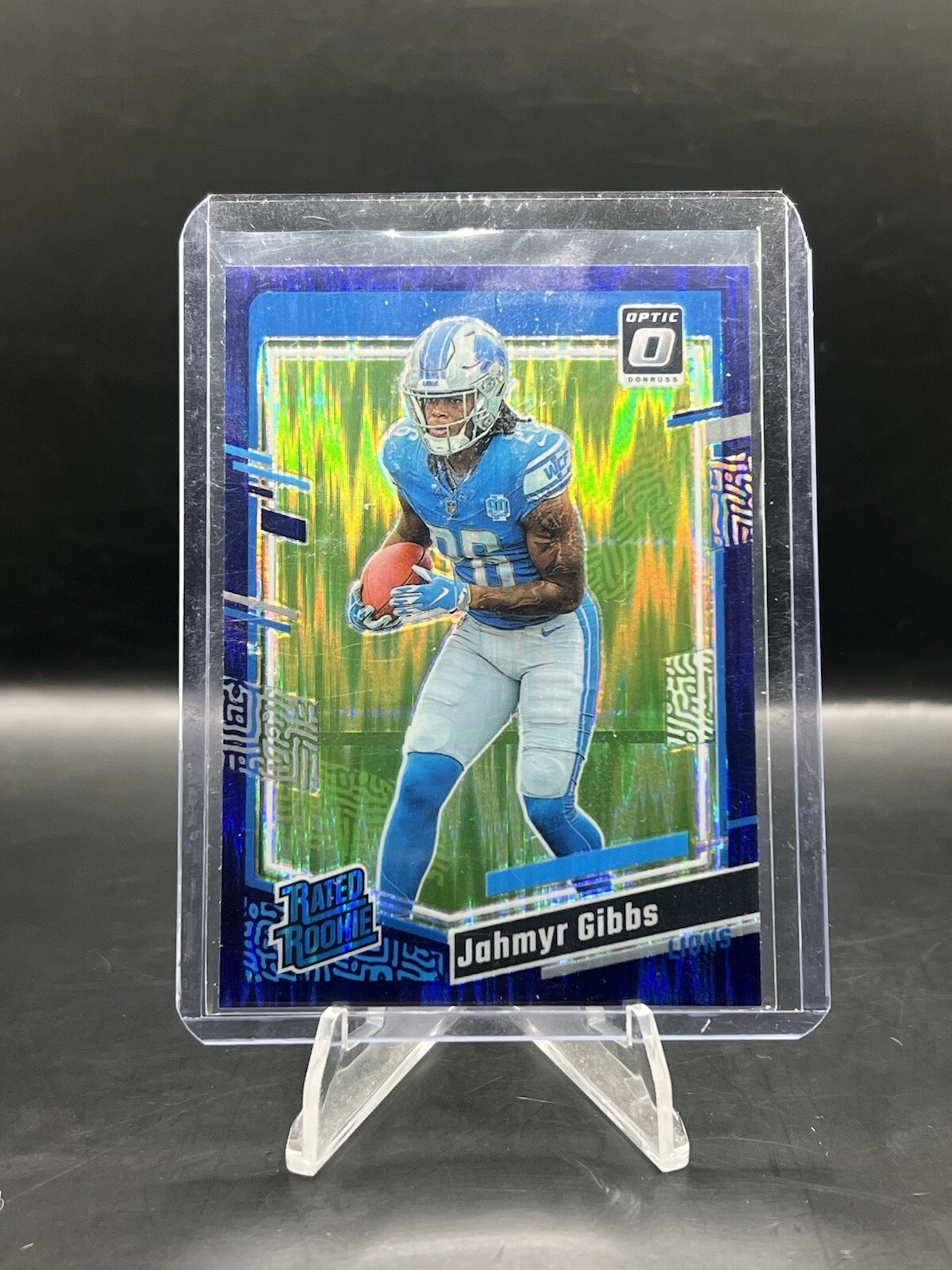 2023 Panini Donruss Optic Jahmyr Gibbs Rated Rookie Purple Shock #236 Lions