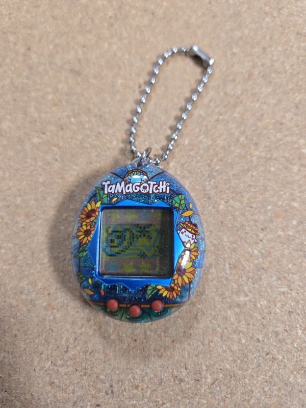 Bandai Tamagotchi virtual pet featuring the "Stained Glass Summer" shell design.