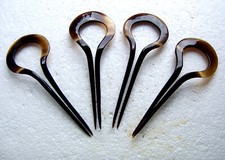Set of four steer horn hair pins or combs in classical arched design