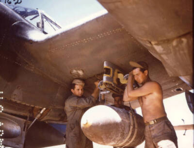Ground crew services a plane in preparation for a flight 1945 Old Photo