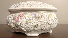 Ceramic Oval Footed Trinket Box White Base w/embossed 3D-colored floral designs.