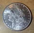 1884 CC BU Morgan Silver Dollar R104