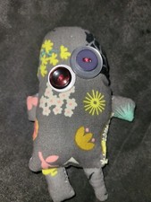Mini Fabric Monster With A Black And A Redish/brown Button Eyes