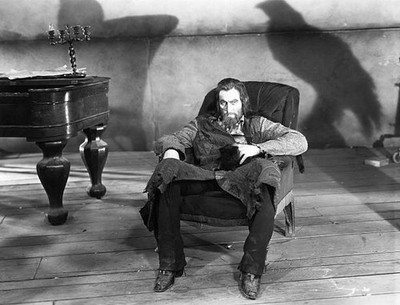 John Barrymore as Svengali evil hypnotist seated a haunted environ- Old Photo