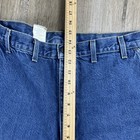 Blue denim Y2K Carhartt men’s carpenter jeans with faded thighs, five pockets, and visible white belt loops.