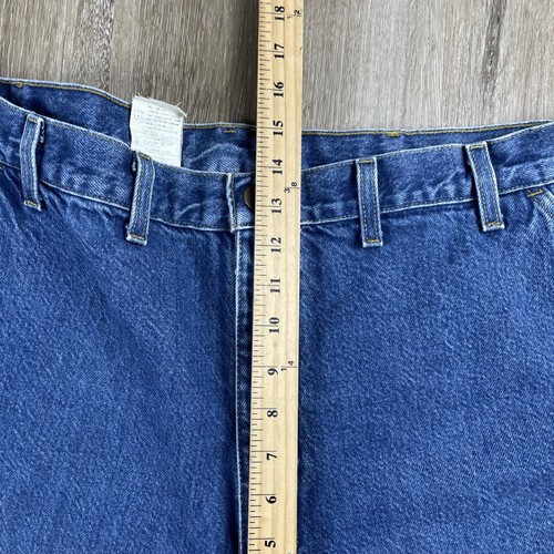 Blue denim Y2K Carhartt men’s carpenter jeans with faded thighs, five pockets, and visible white belt loops.