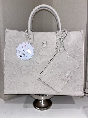 NWT BETSEY JOHSON  EMBOSSED SKULL DESIGN WITH NON REMOVABLE STRAPS HANDBAG