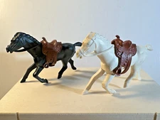 Vintage soft Plastic REL 60mm horses with Marx original brown vinyl saddles.