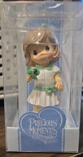 Precious Moments October birthstone miniature figurine featuring a girl holding