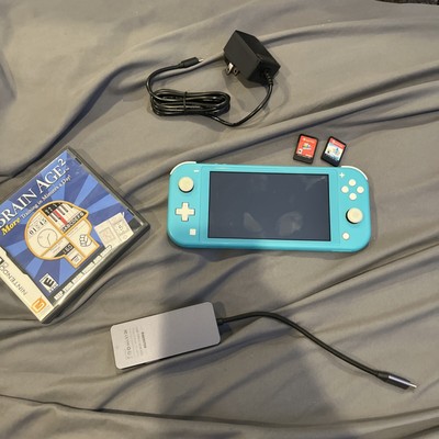 Nintendo Switch Lite Torquise Basically New With Mario Odessy And Pokemon Sheild