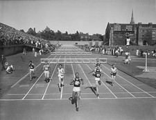 Jesse Owens of Ohio State winning the 220 yard low hurdles event i- Old Photo