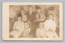 Postcard RPPC Children Family Group Portrait Interior Home Sepia Tone 1900's