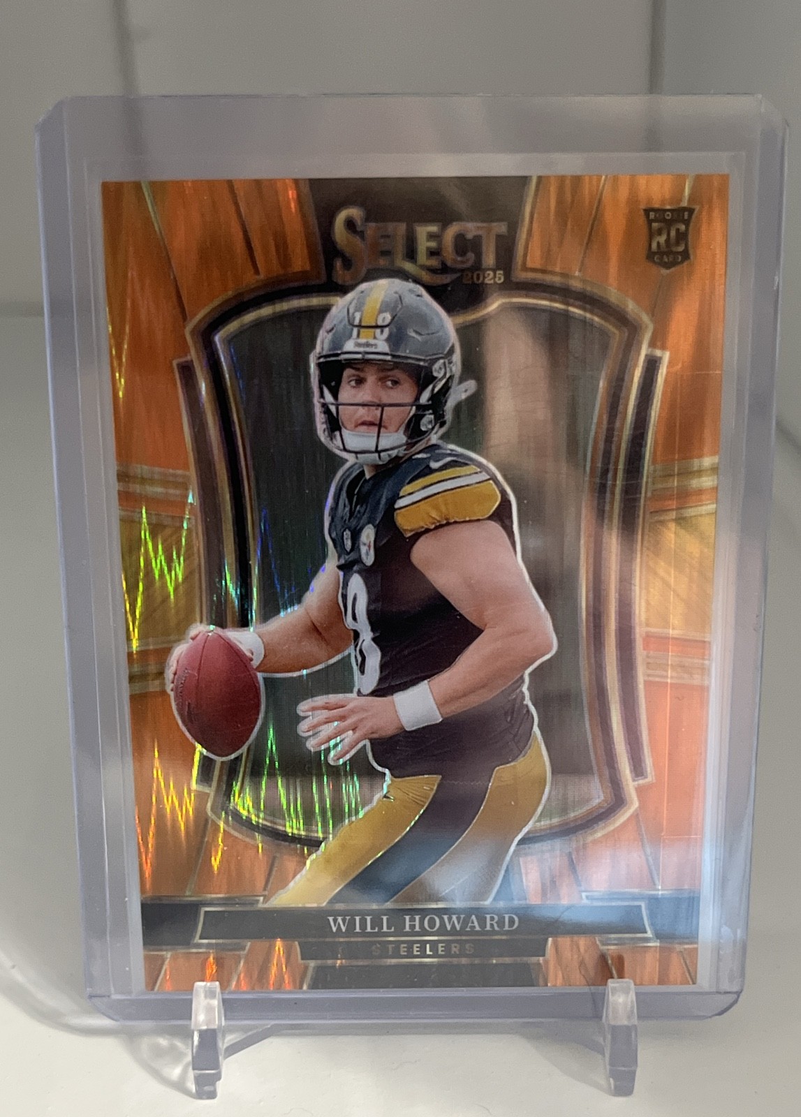 2025 Panini Select - Premier Level Will Howard #152 Orange Shock Prizm /399 (RC)