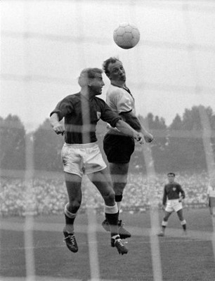 The German Uwe Seeler scores against Poul Jensen of Denmark a head- Old Photo