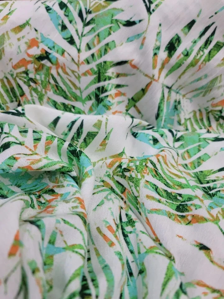 Tela de Rayón por Yarda - Estampado Hawaiano con Hojas Verdes y Palmeras en Blanco Foto 3 de 4