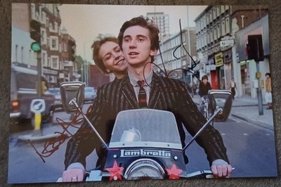 leslie ash on the back of phil daniels bike during filmscene signed 12x8 photo