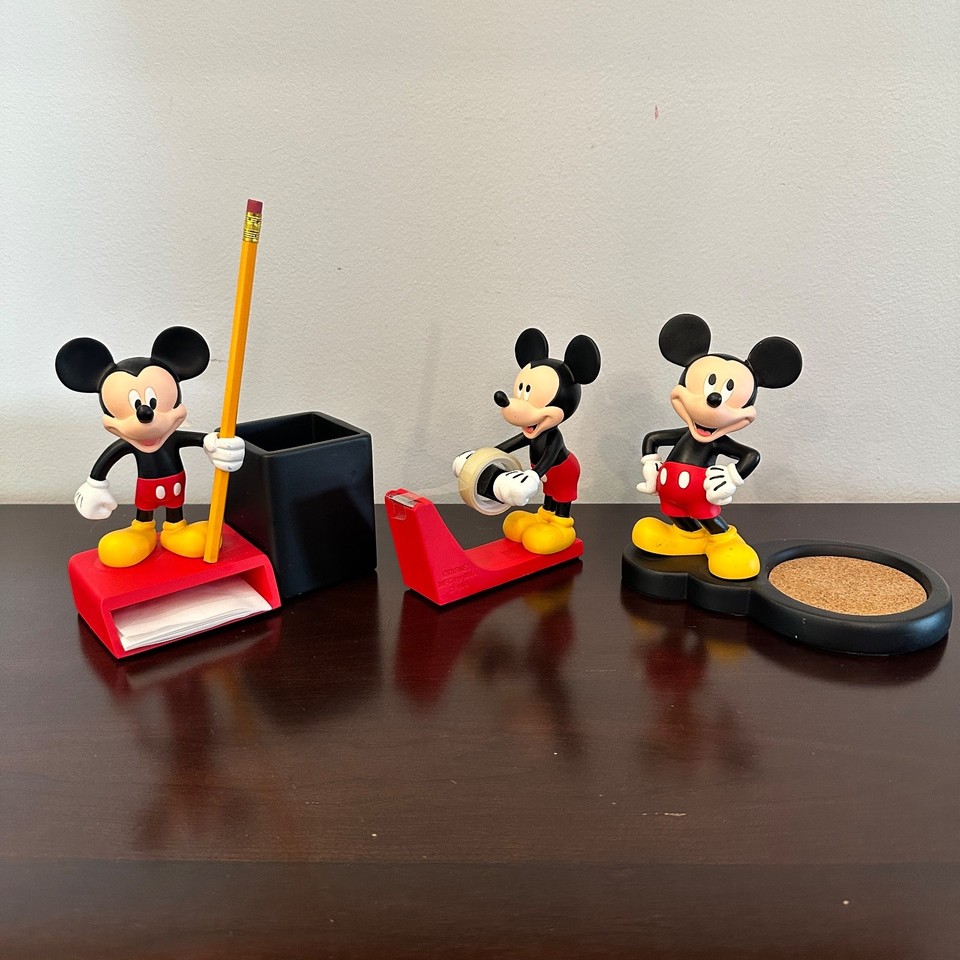 A matched vintage Mickey Mouse desk set — tape dispenser, pencil holder, and cup — the kind of Disney collectible that actually gets used.