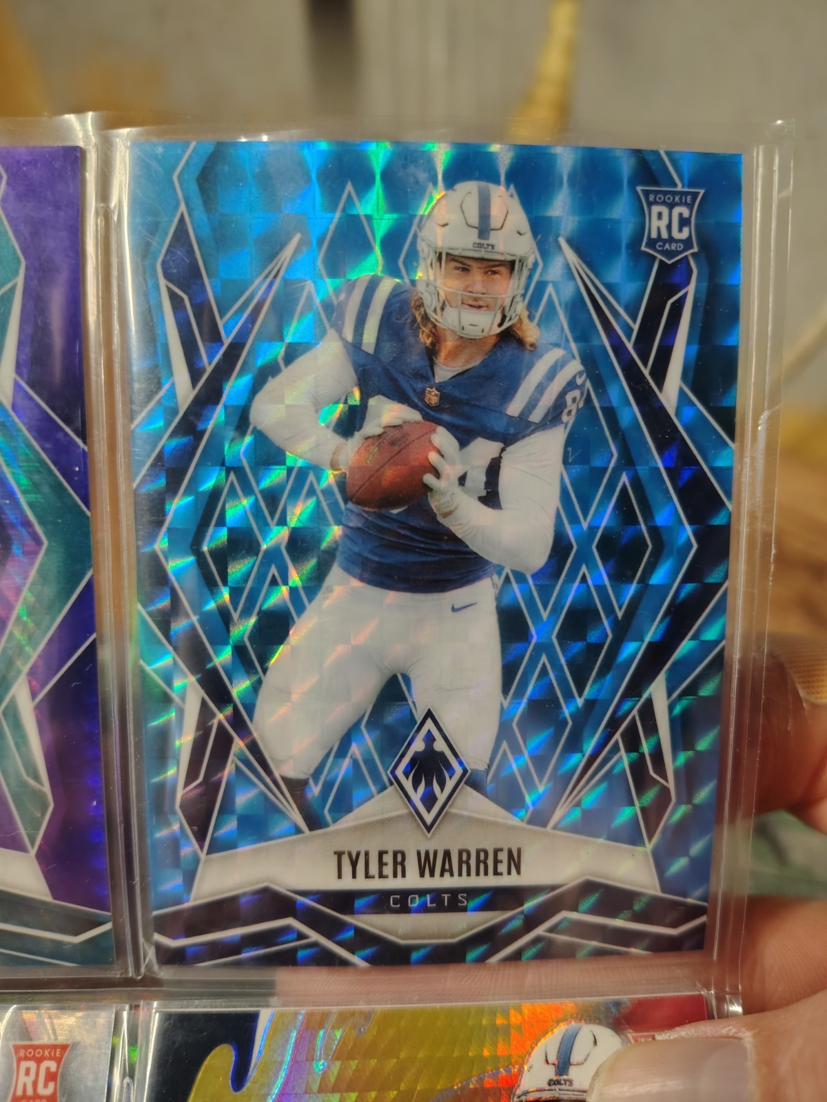 2025 Panini Phoenix - Rookies Tyler Warren #185 Light Blue Pyramids /385 (RC)