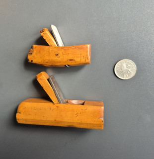 Two antique miniature boxwood smoothing planes complete with irons.