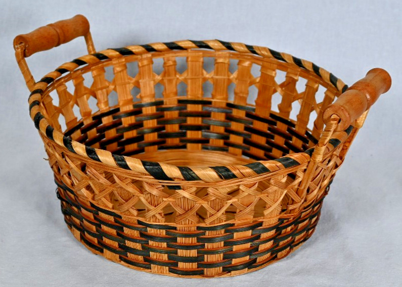 Woven rattan seagrass basket with wood handles and black accent