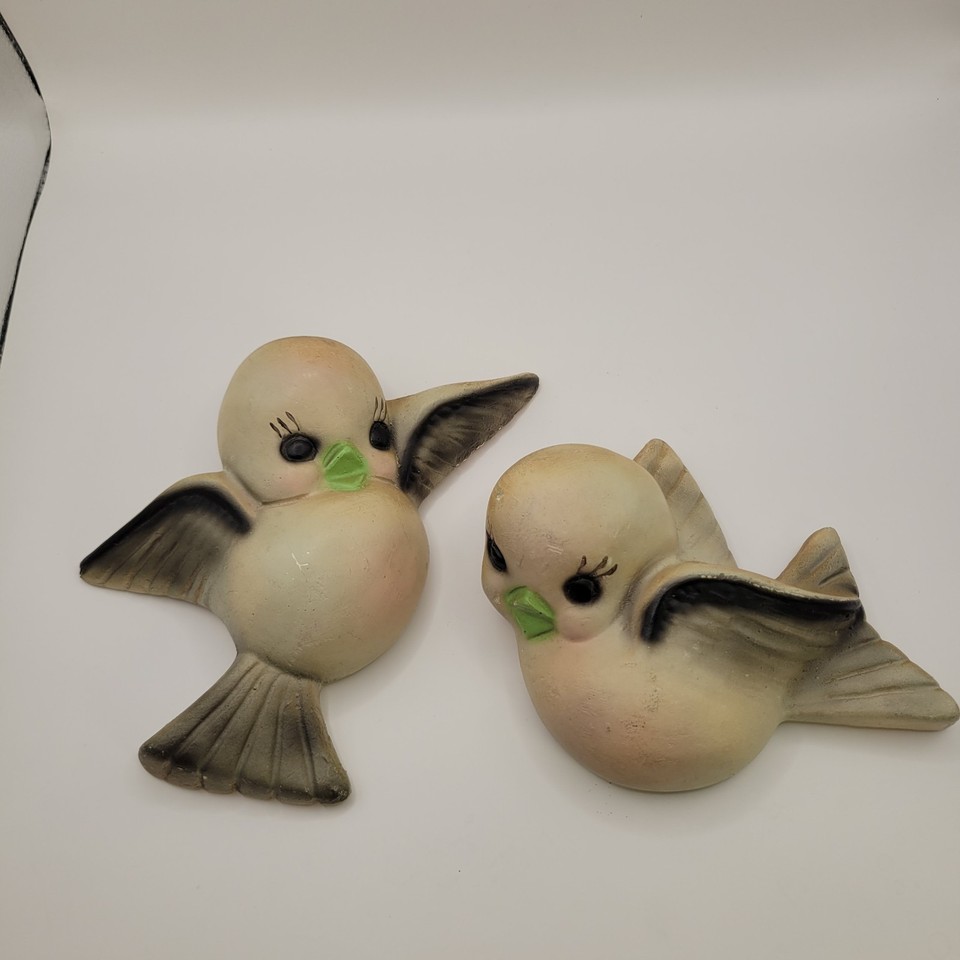Gray and pink chalkware bird wall art from the kitsch golden age — the kind of retro wall décor that Instagram vintage hunters actively hunt.