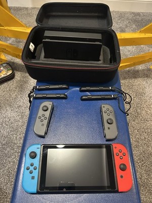 Nintendo switch, TV adapter and cases plus Mario kart steering wheel  