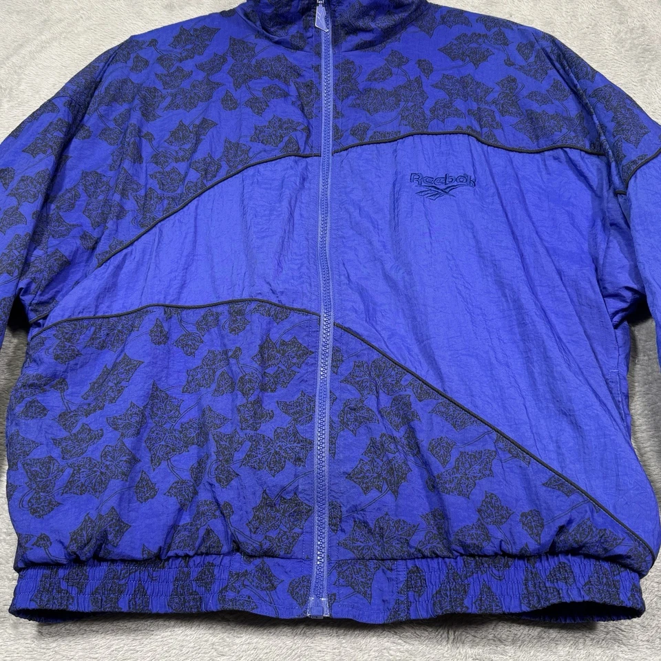Chaqueta cortavientos de colección Reebok años 90 talla M estampado de hojas azul negro nailon pista retro Foto 3 de 4
