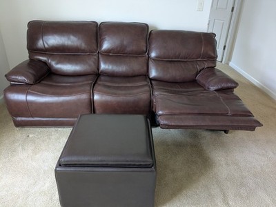 Brown Leather reclining couch. Plus brand new large hassock.